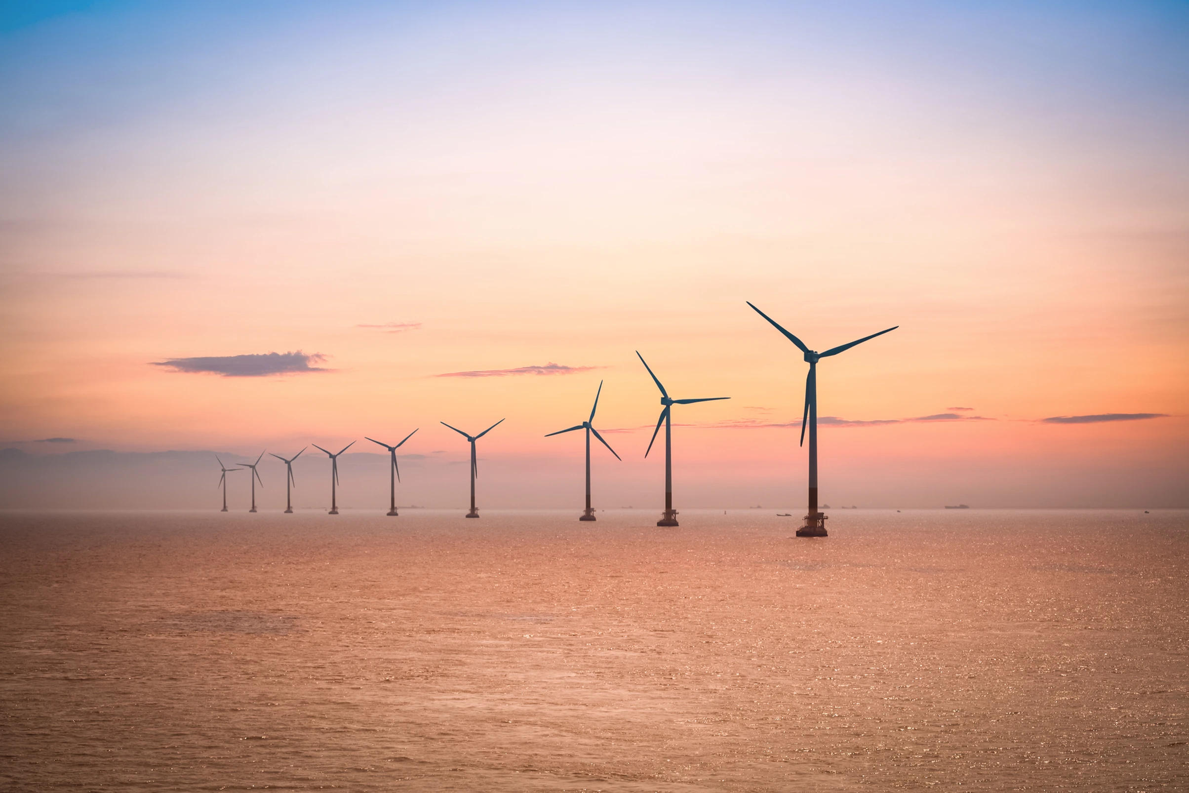 Offshore turbines at sunset